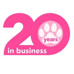 A pink sign that says 20 years in business with a paw print A pink sign that says 20 years in business with a paw print