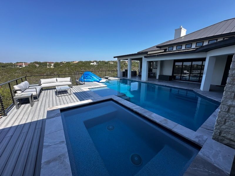 A swimming pool with a waterfall on the side of it