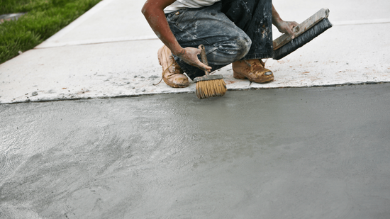 Concrete contractor finishes a sidewalk in Naperville