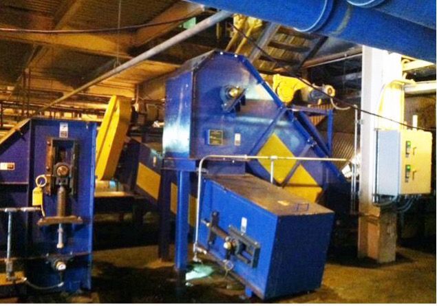 Blue and yellow industrial machinery in a factory setting.