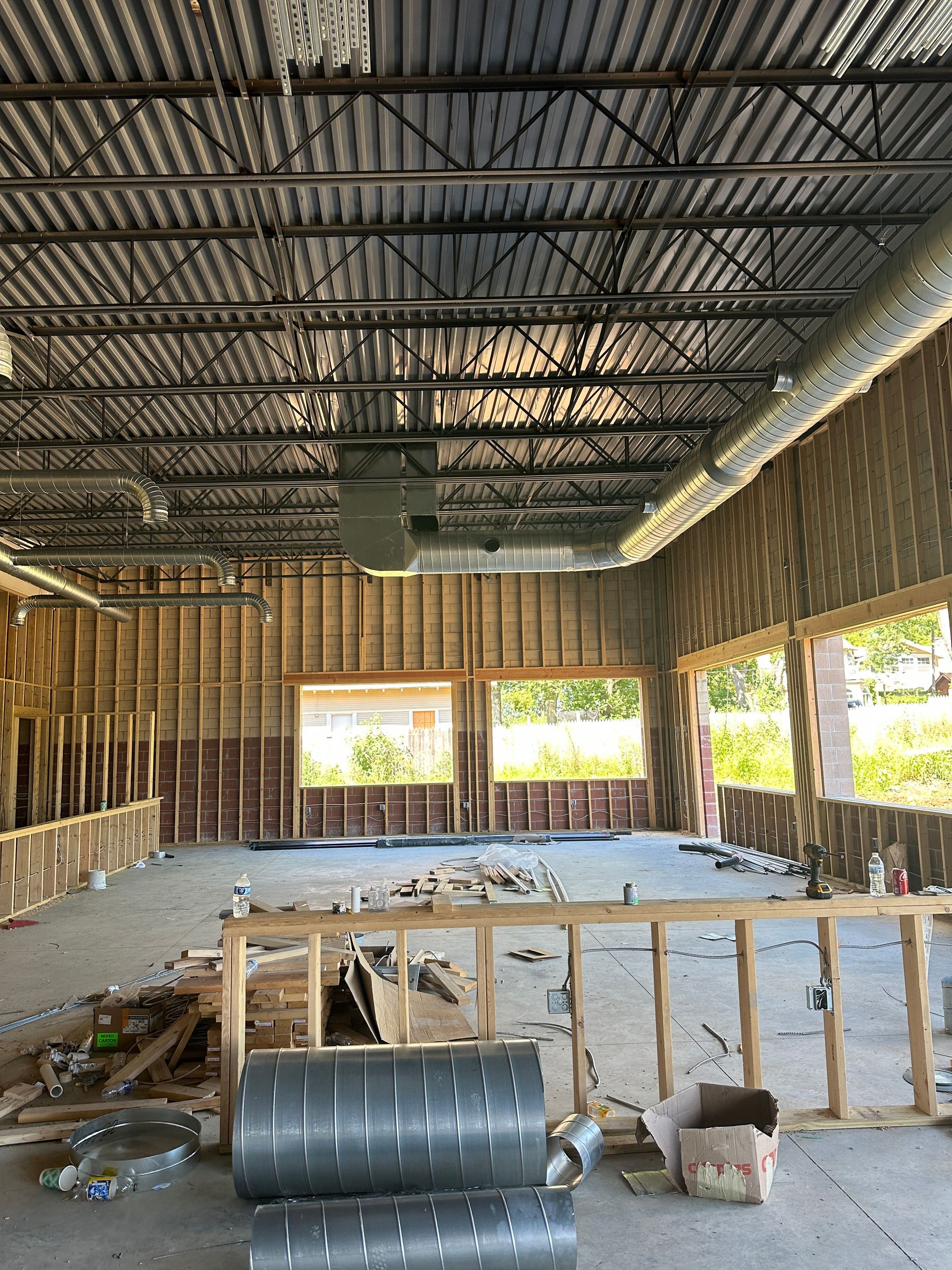 The inside of a building under construction with a lot of windows.