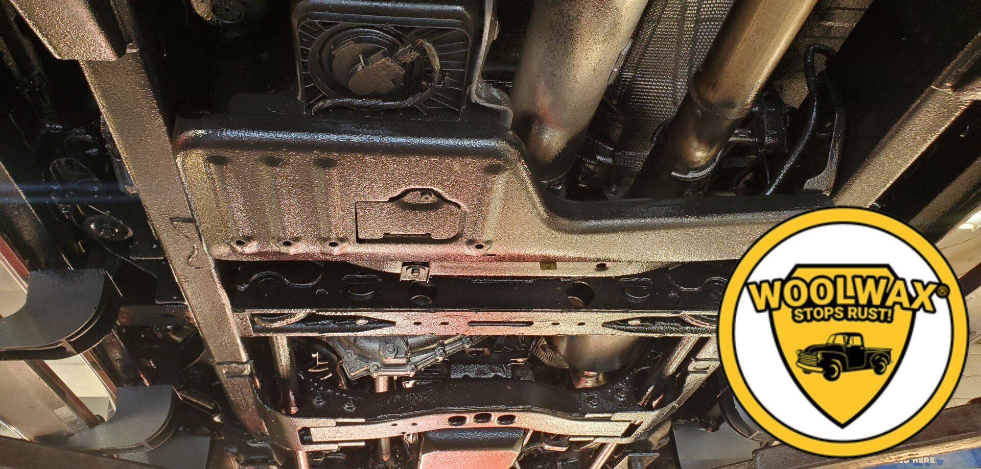 a picture of the underside of a car with woolwax written on it