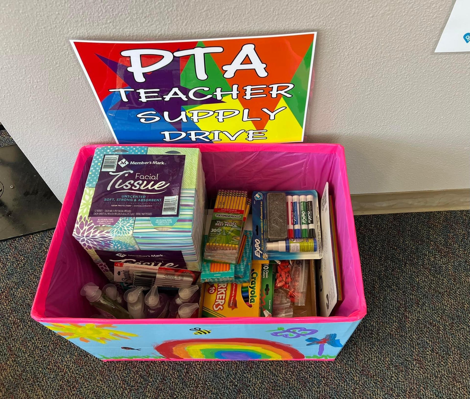 PTA teacher supply drive bin with tissues, school supplies, and colorful sign.