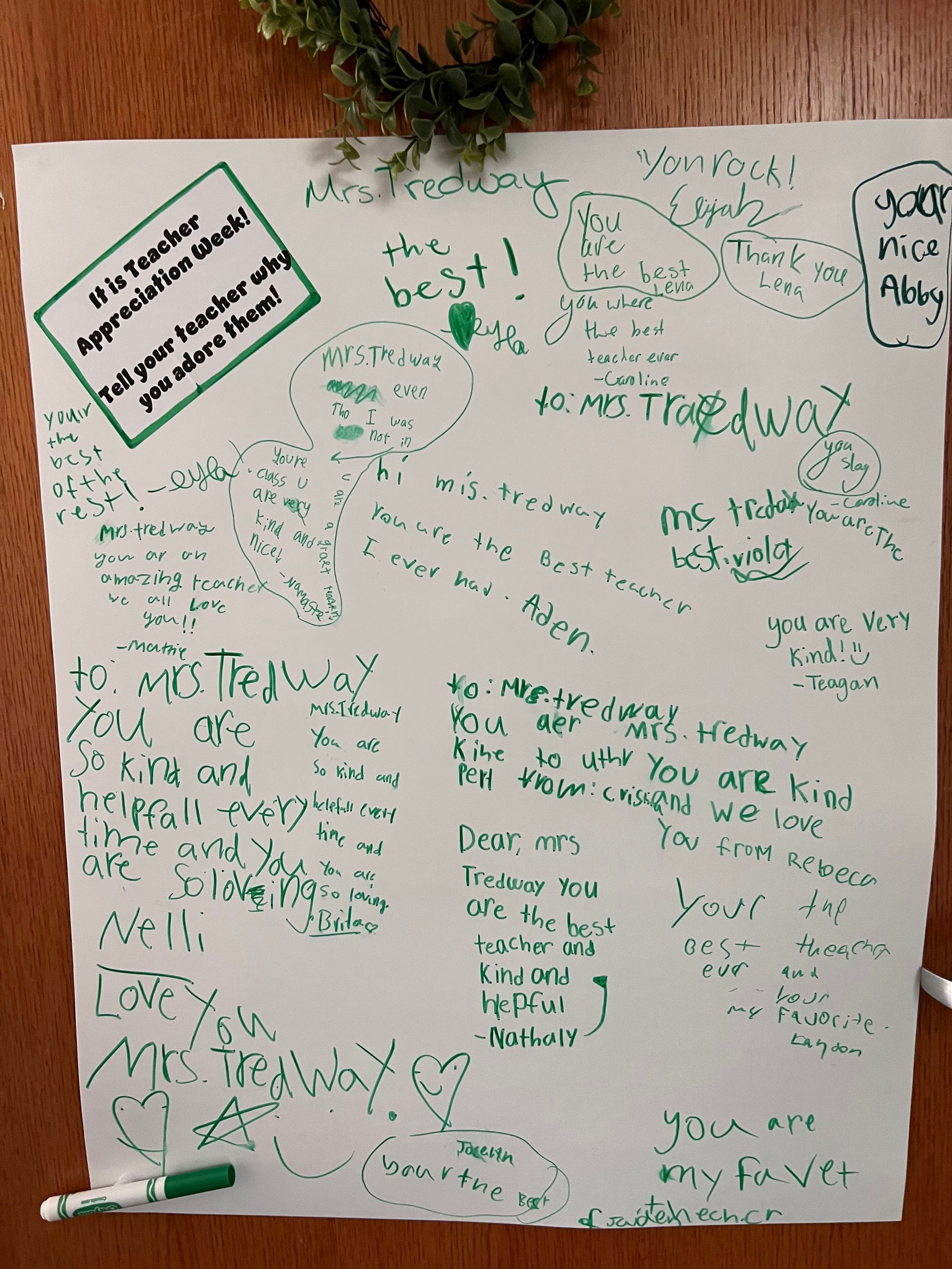 White paper with green handwritten messages and signatures.