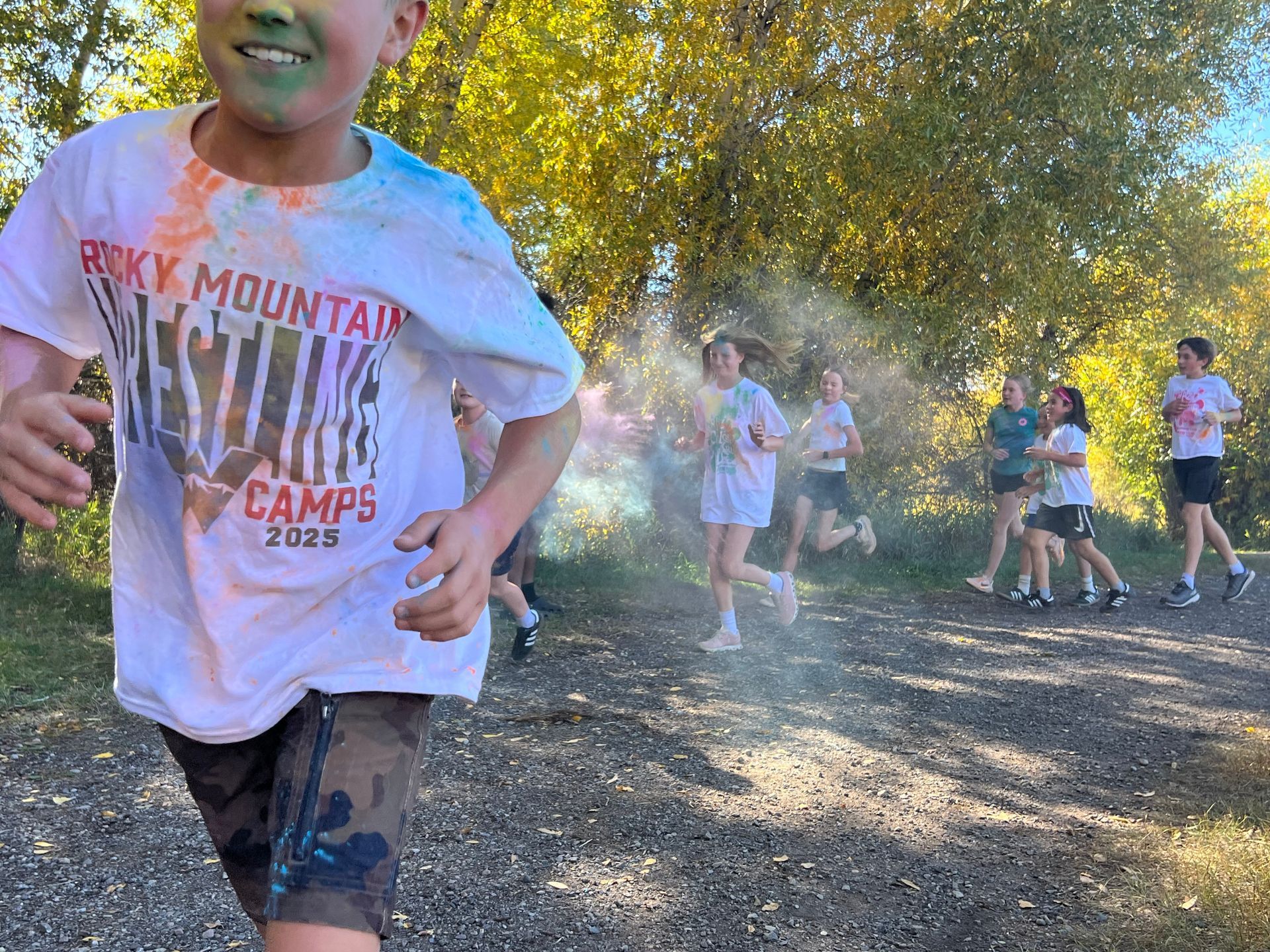 Children running through colored powder; outdoor race.