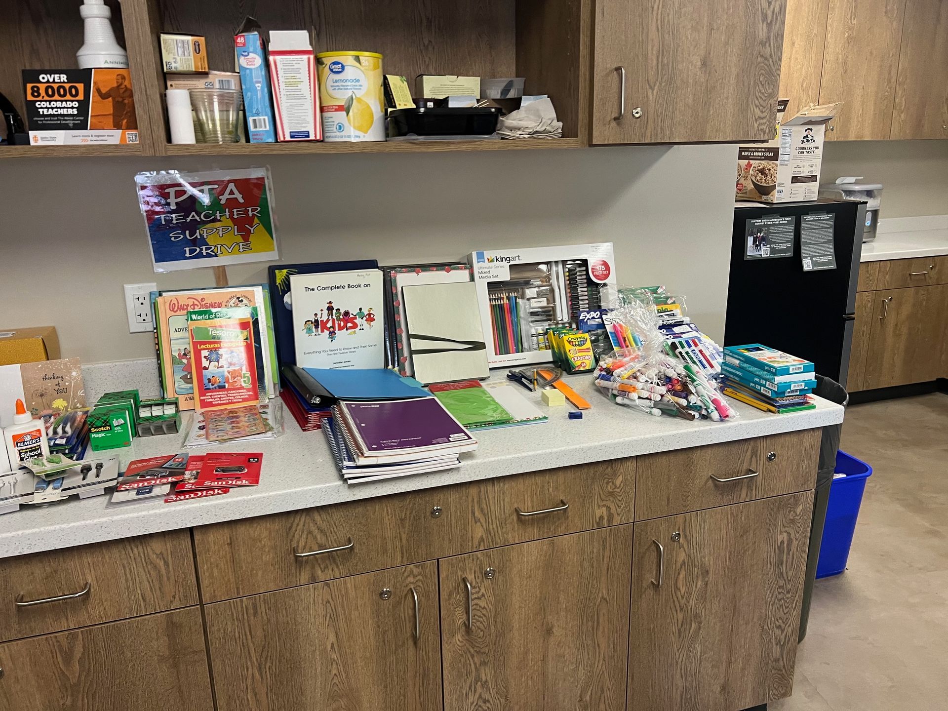 Countertop with school supplies and snacks; cabinets above and below.