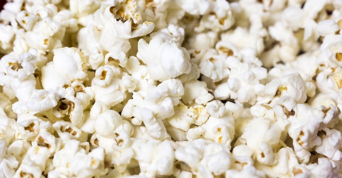 Close-up of fluffy white popcorn, some with light brown kernels.