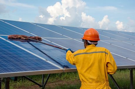 Worker Cleaning The Solar Panels Worker Cleaning The Solar Panels