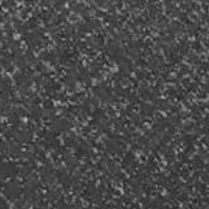 Dark, speckled surface with many light gray and white specks, possibly stone or textured material.