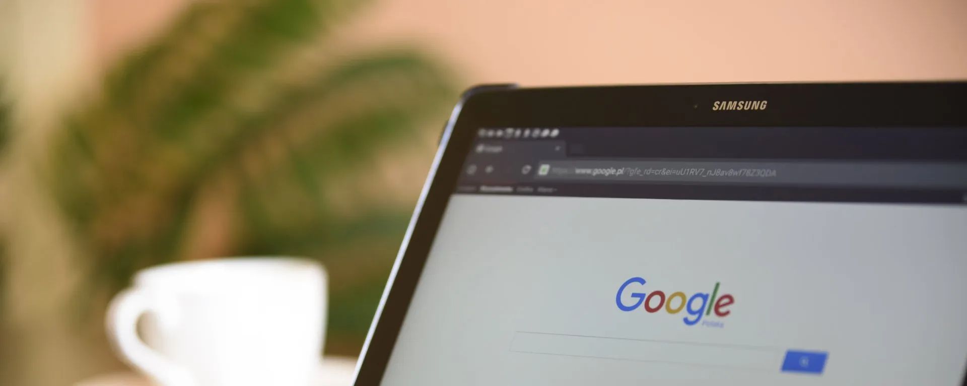 A laptop computer is open to a google search page.