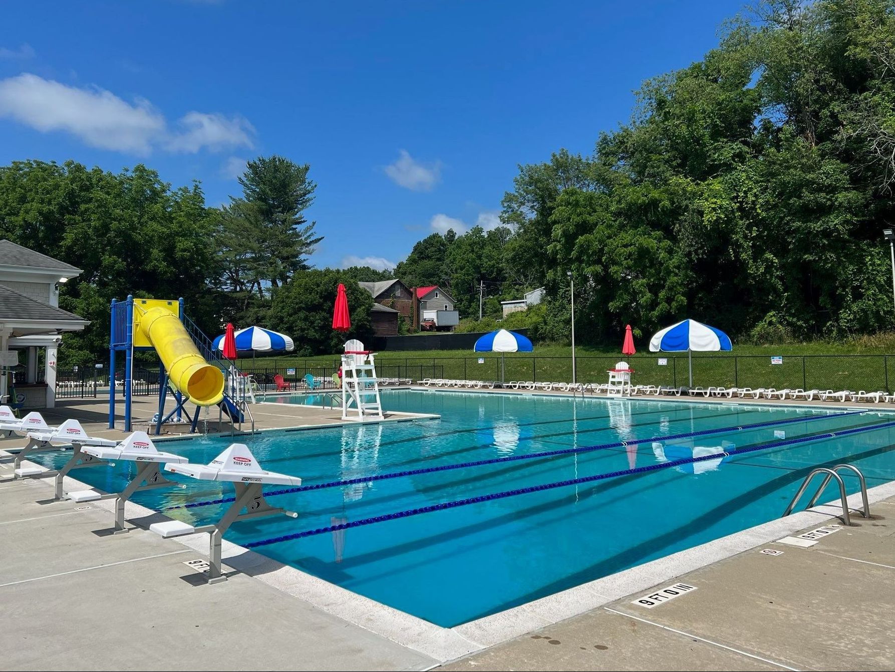 a swimming pool with a lifeguard tower and a slide