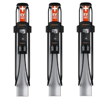 Three ev charging stations are lined up next to each other