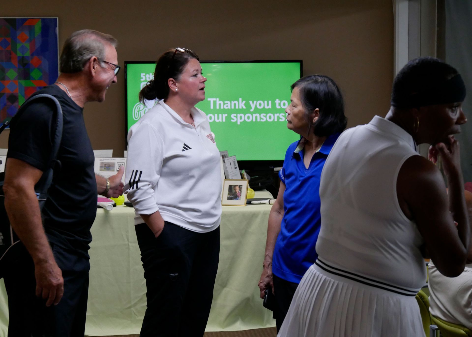 Pickleball tournament director Chrissy Haywood talks to tournament participants.