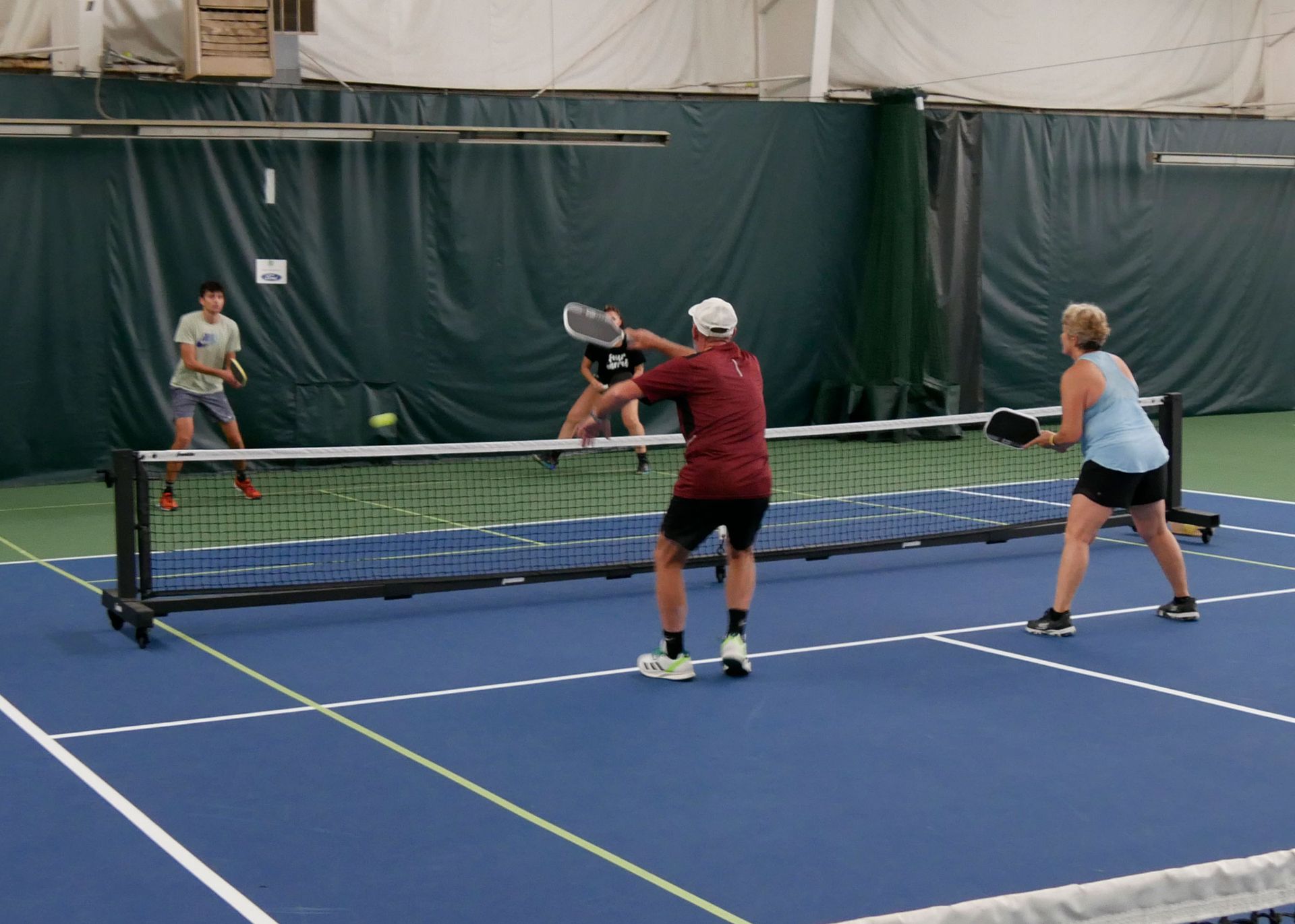 Pickleball doubles teams playing.