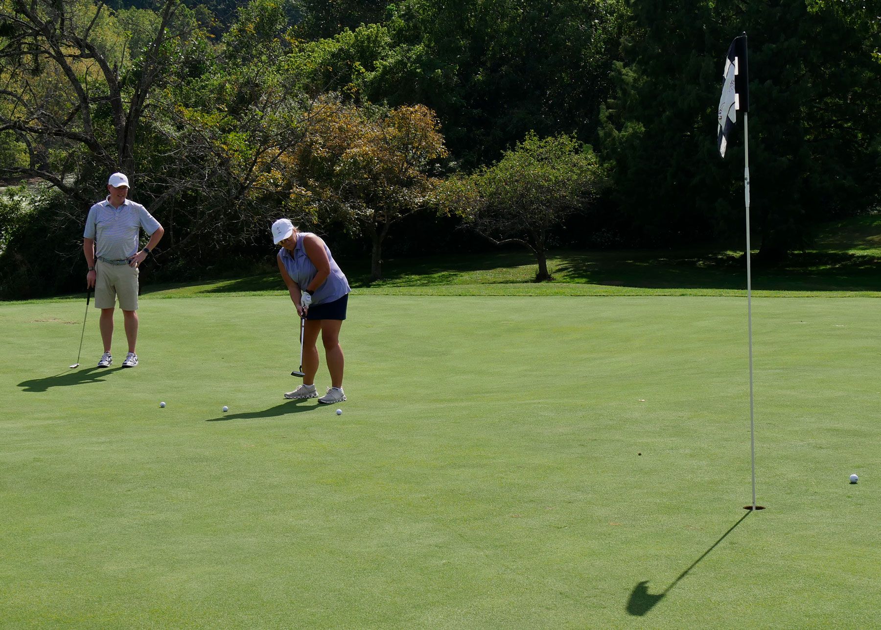 Debbie Baldwin puts while her teammate watches.