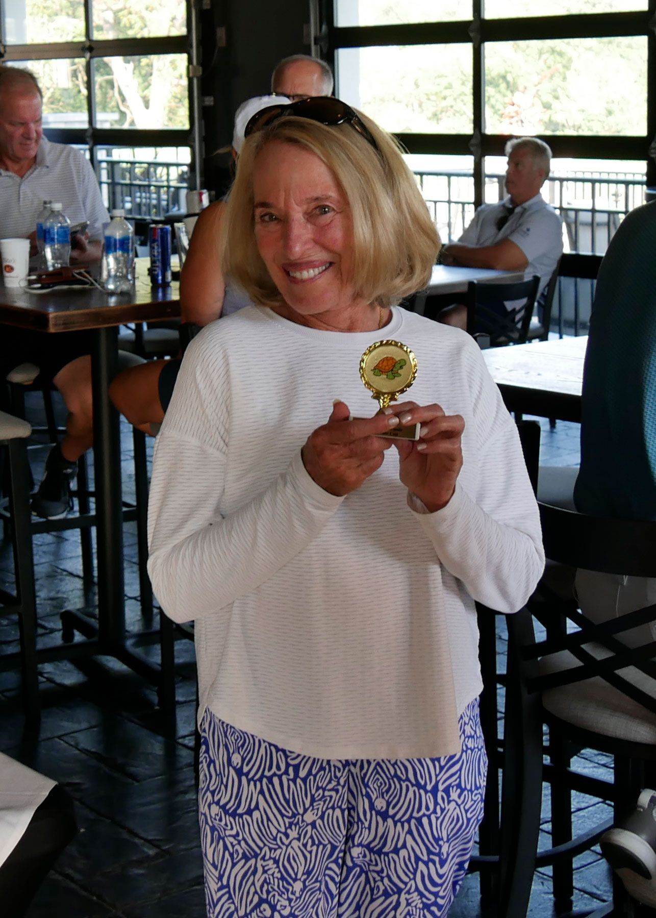 Maxine Bizer poses for a photo with the Turtle Award.