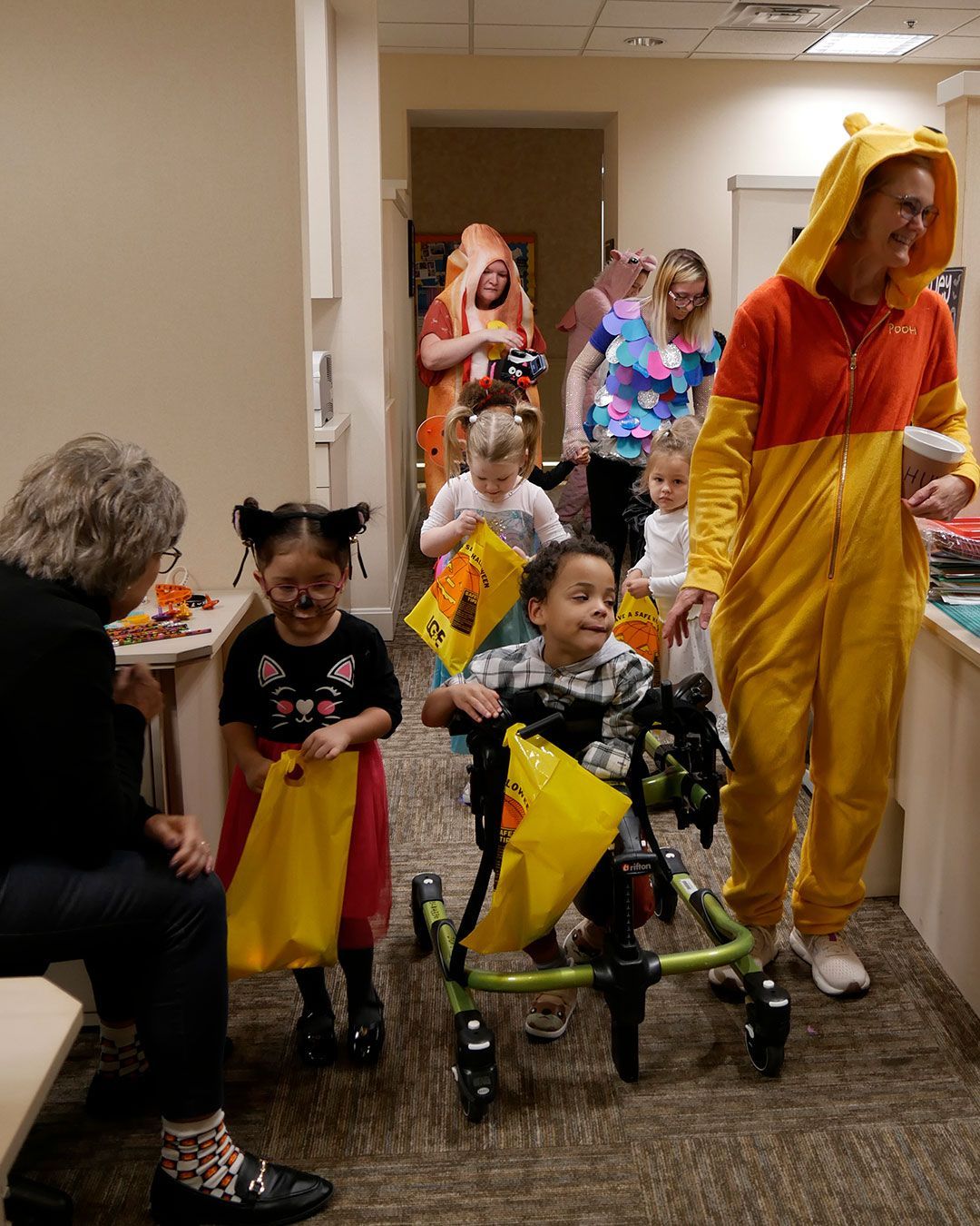 The kids make their way through the teacher's office area.