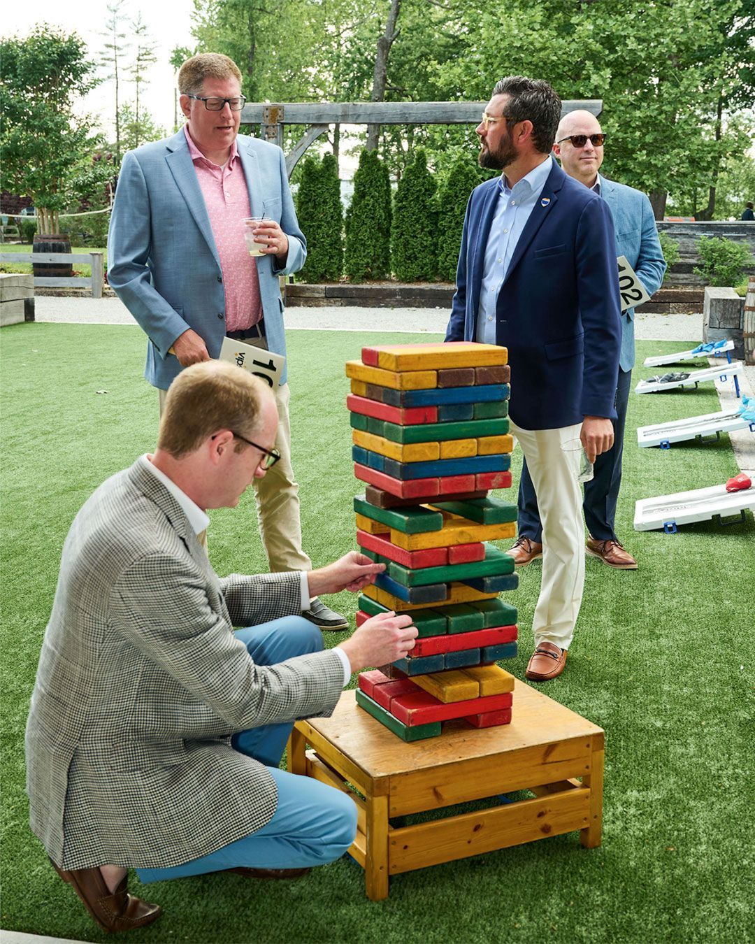 A man plays a giant Jinga on the lawn at Progress Park.