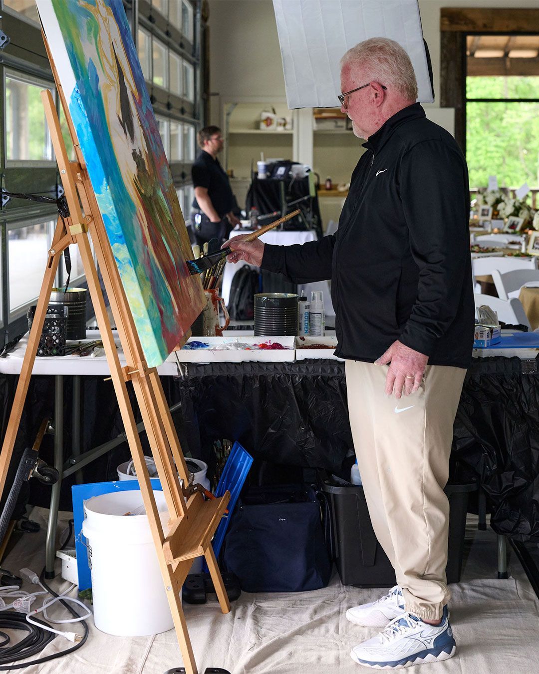 An artist creates a painting for the auction at the 2025 VIPS Gala.