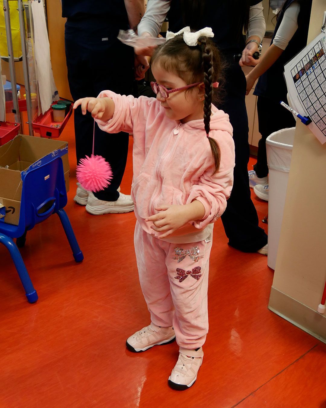 A small girl plays with her new 'germ' toy.