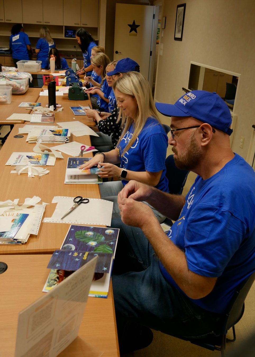 Baird volunteers place braille translations into the new books.