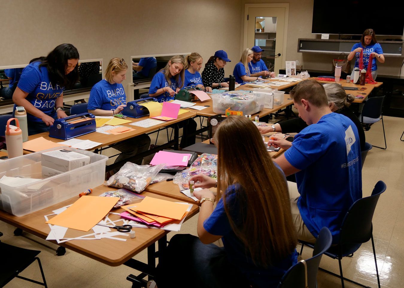 Baird volunteers sitting in the conference room working on various projects.