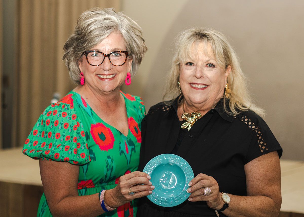 Kathy Mullen and Diane Nelson pose for a photo. Diane is accepting the smokin' hot award for her excellence in leadership.
