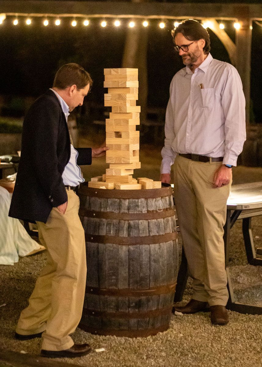 Two men play a block-stacking game during the Gala after-party.