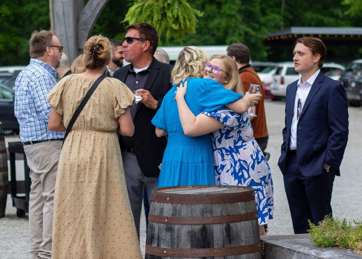 Gala attendees hug and greet each other at Progress Park before the program begins.