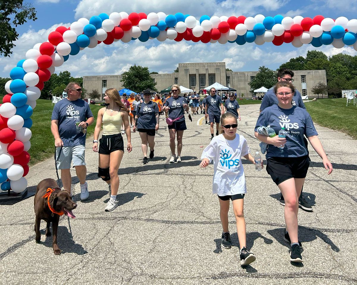 Walkers under the balloon arch at Walking for Dreams.