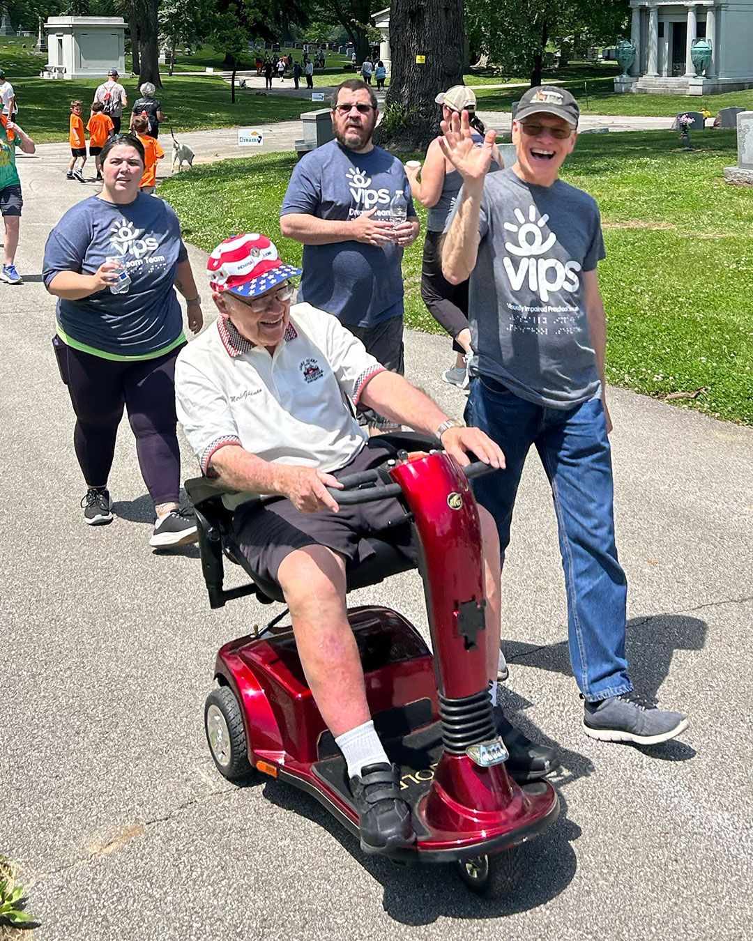 A group of VIPS supporters waves at the camera during Walking for Dreams.
