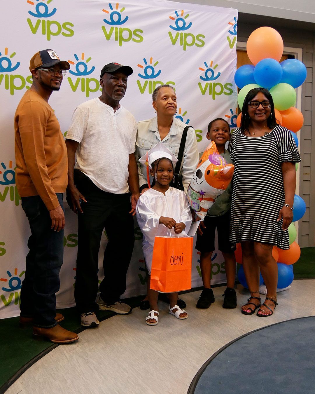 A family poses for a photo with a graduate.