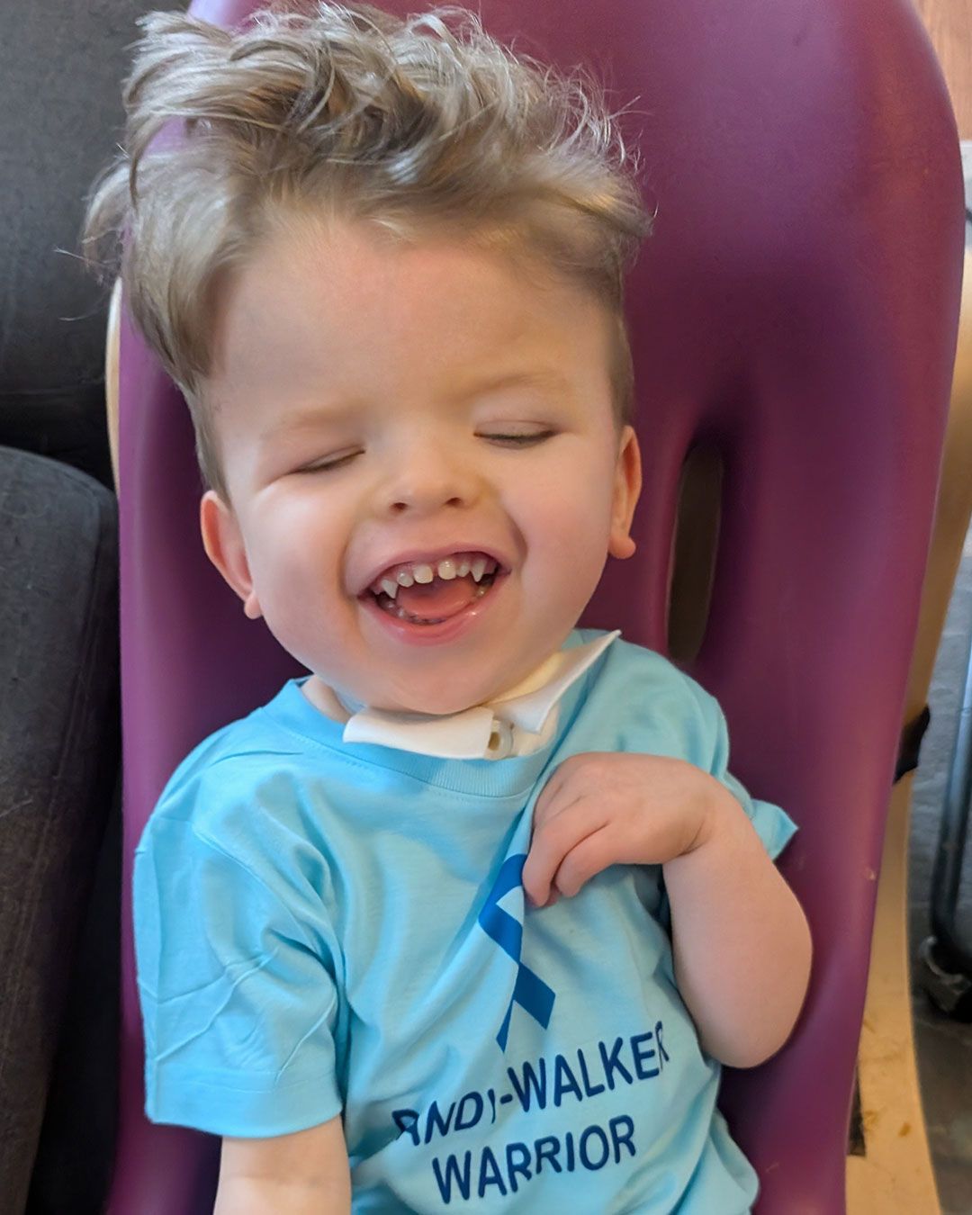 Sonny is sitting up and laughing.