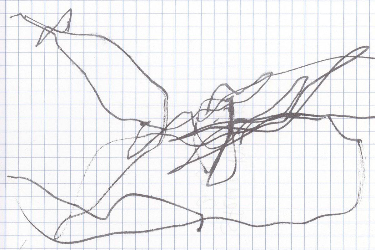 A child-drawn snowflake made on graph paper with scribbles in black marker.