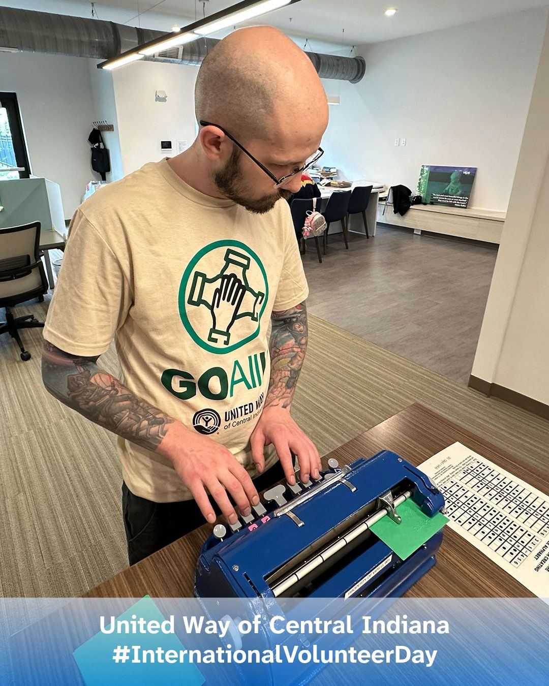 A volunteer from United Way of Central Indiana uses a Brailler at the VIPS Indiana office.