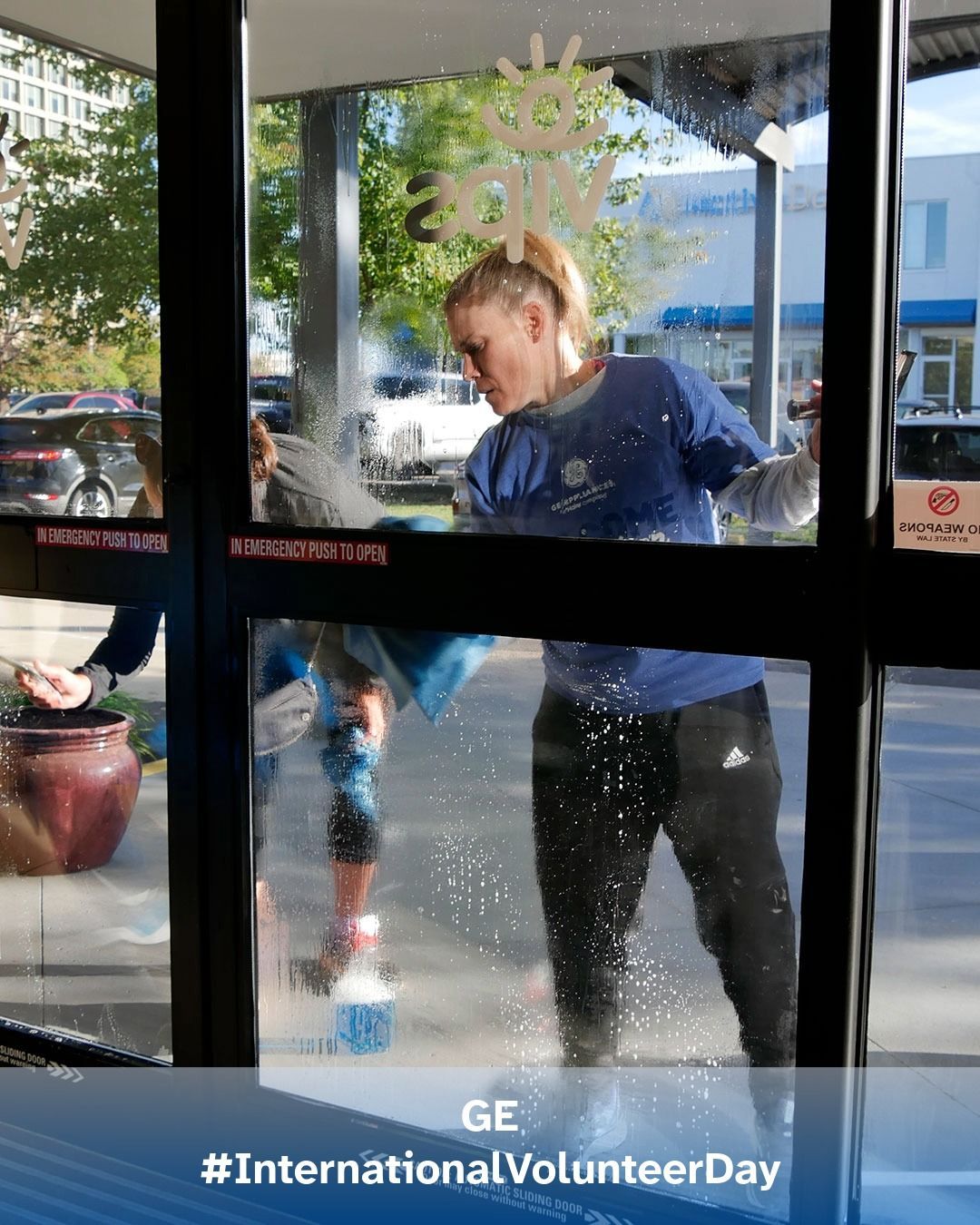 Volunteers from GE wash windows at VIPS Louisville.