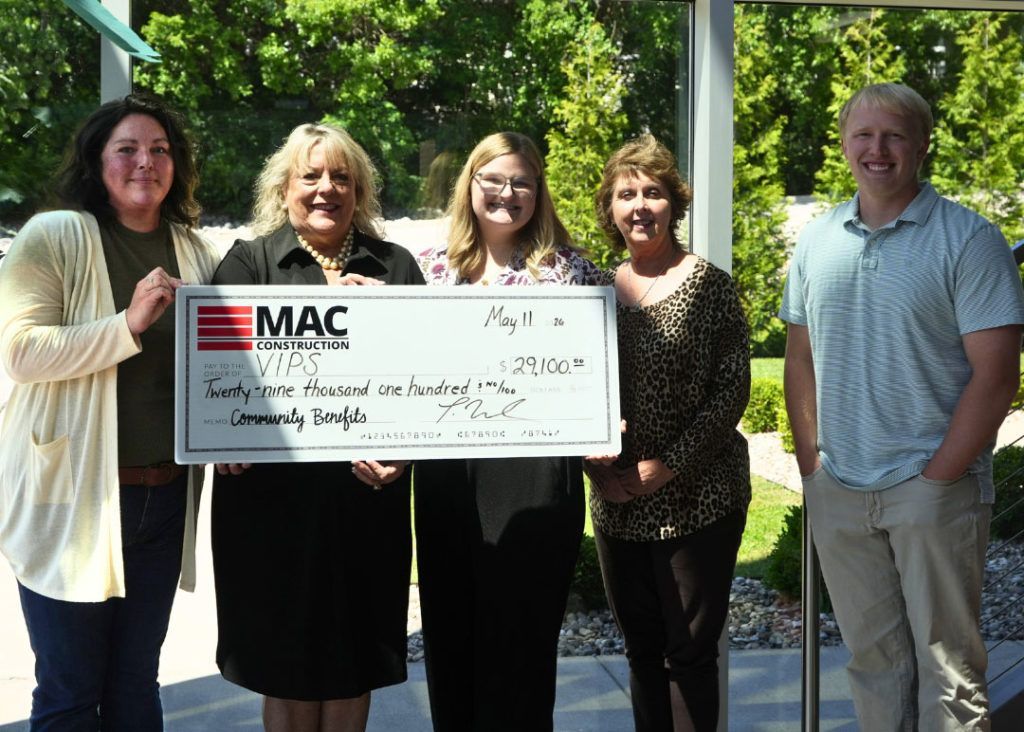 Diane Nelson, Justine Aycock, and MAC Construction staff members pose for a photo with a giant check for $29,100.