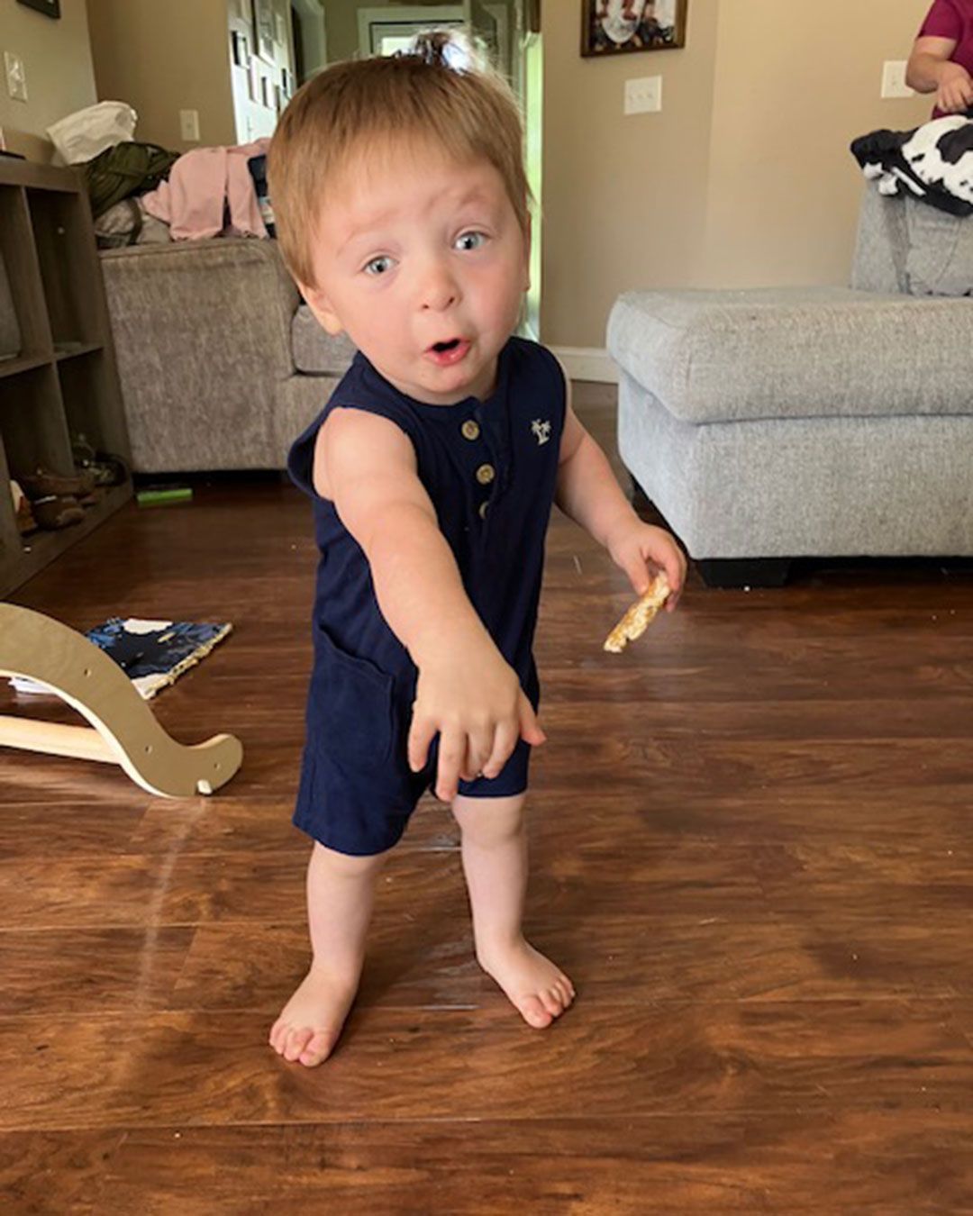 Luke is standing in the living room and posing for a photo.