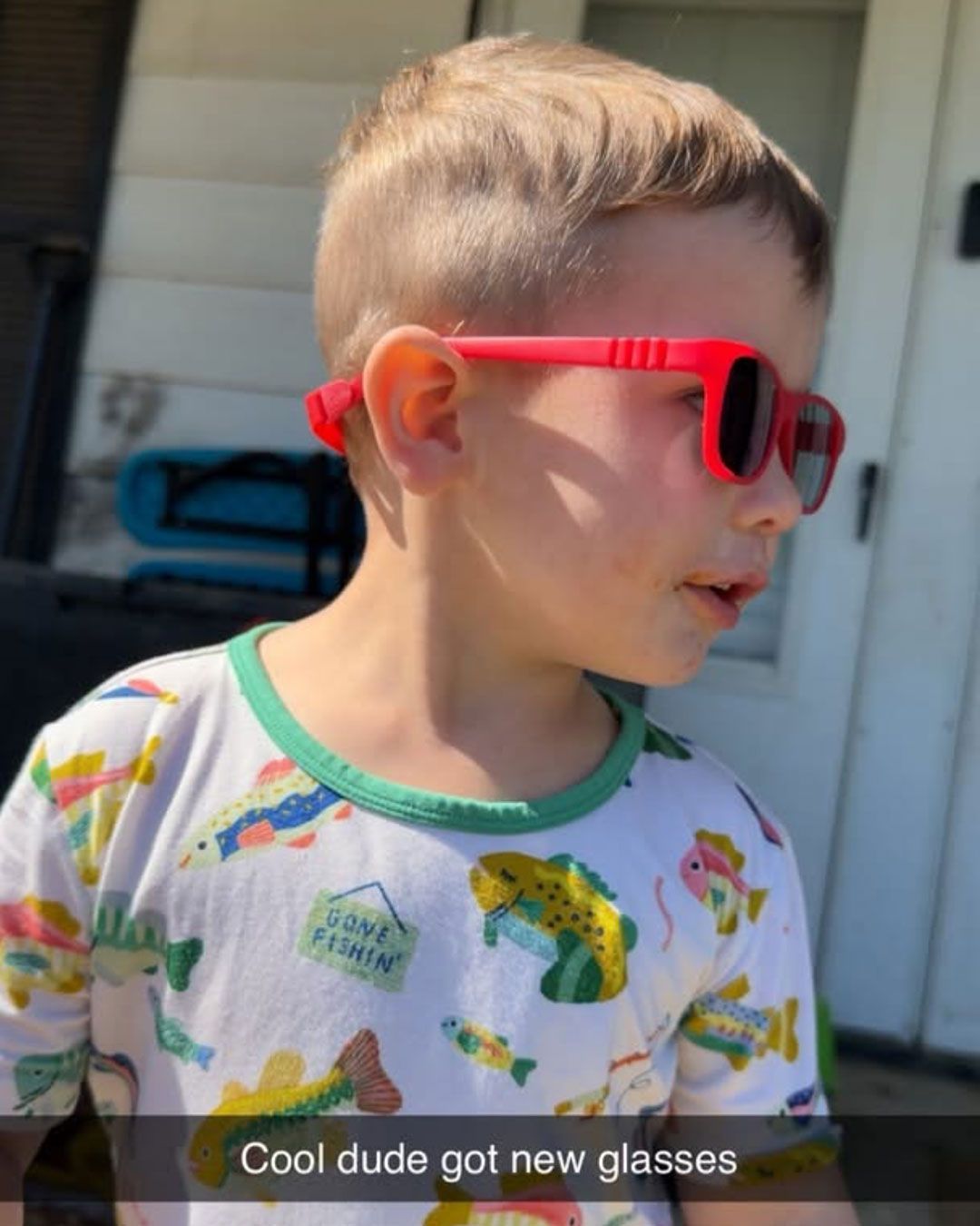Wilder is showing off his wearing red prescription sunglasses.