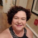 Woman smiles at the camera.