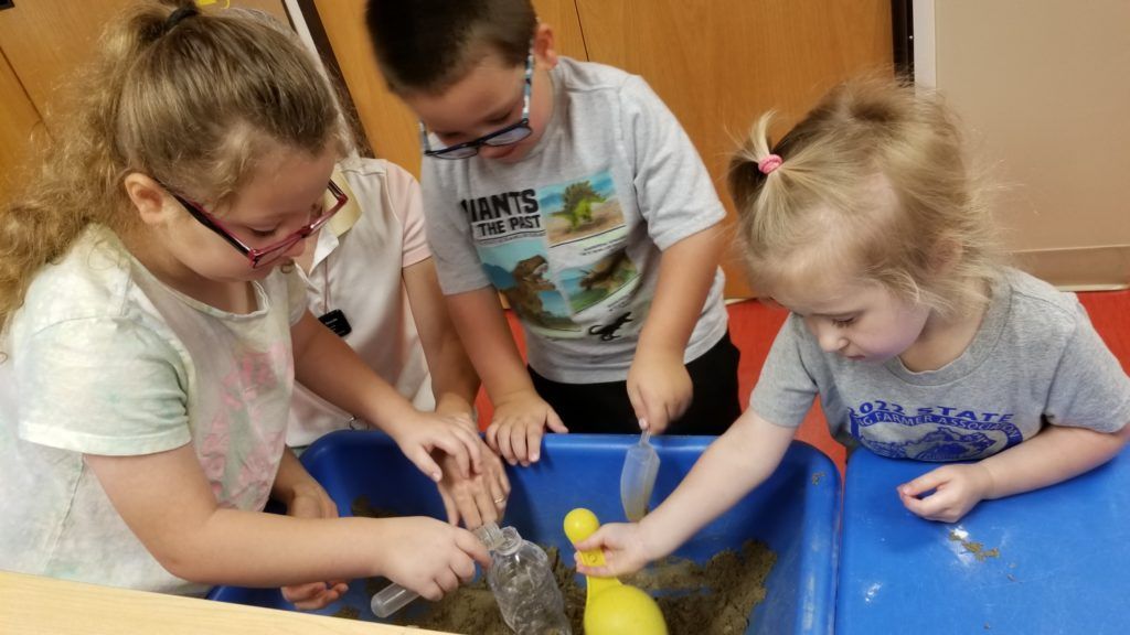Children making a volcano in class