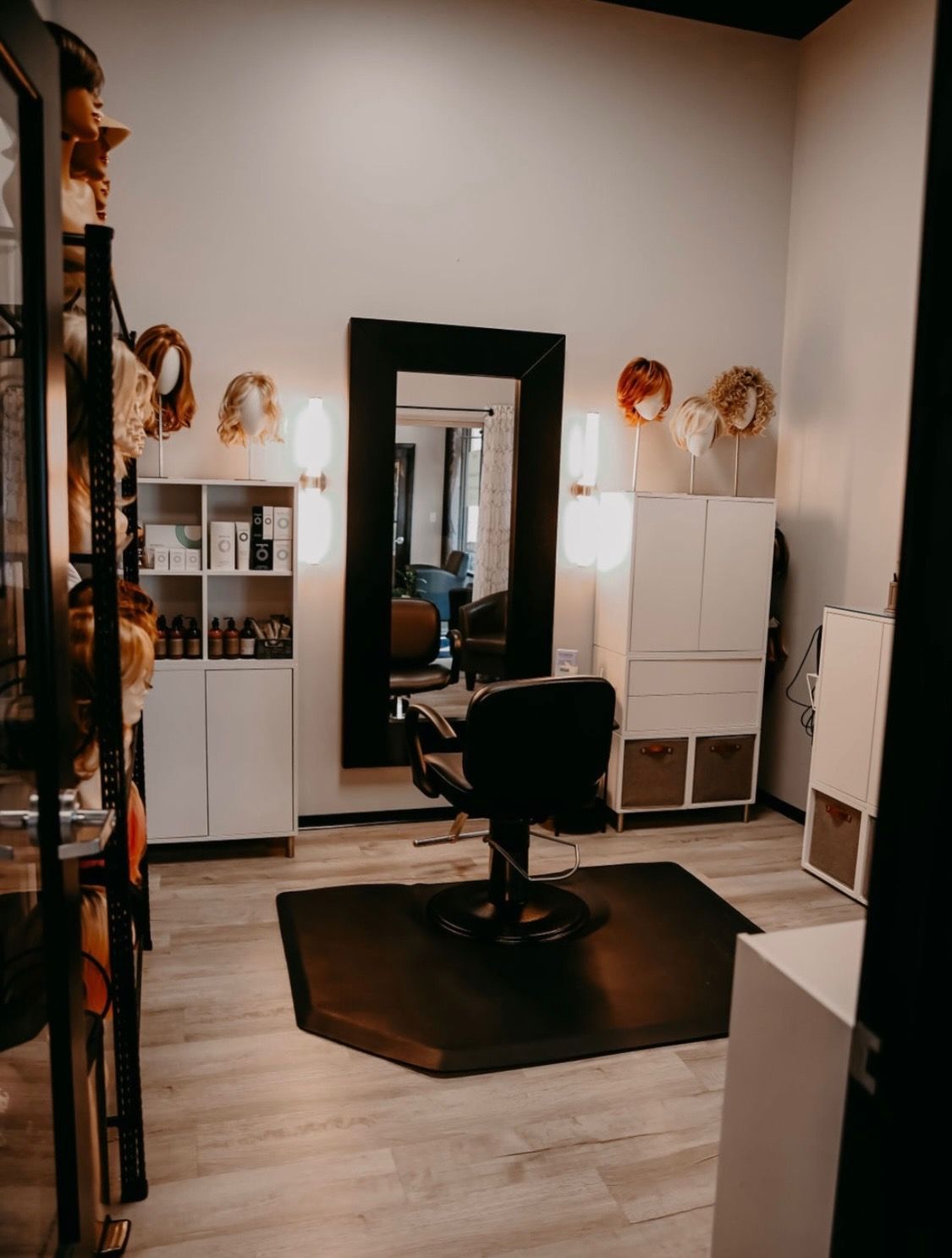 A room with a chair and a mirror in it.