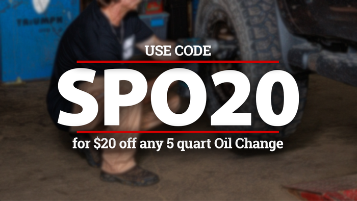 A mechanic works on a vehicle tire overlaid with text: 