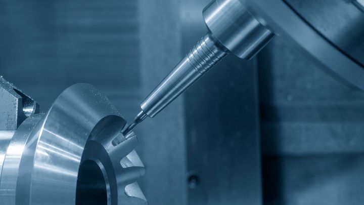 A close up of a machine cutting a piece of metal