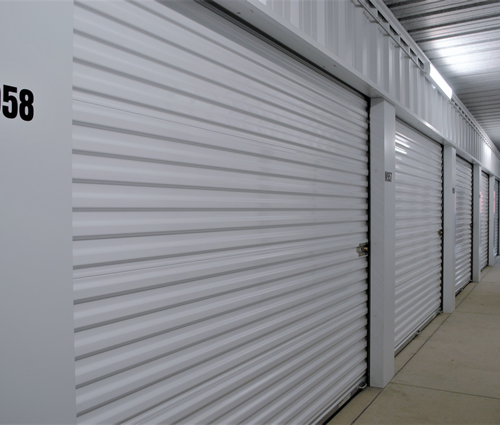 Alliance Self Storage Springfield - indoor storage unit with white door