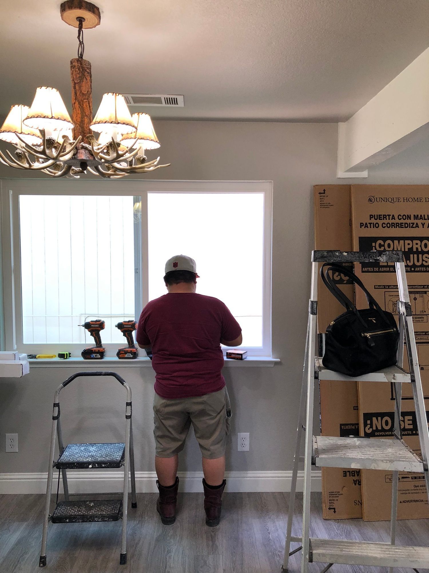 a man is standing in front of a window in a room .