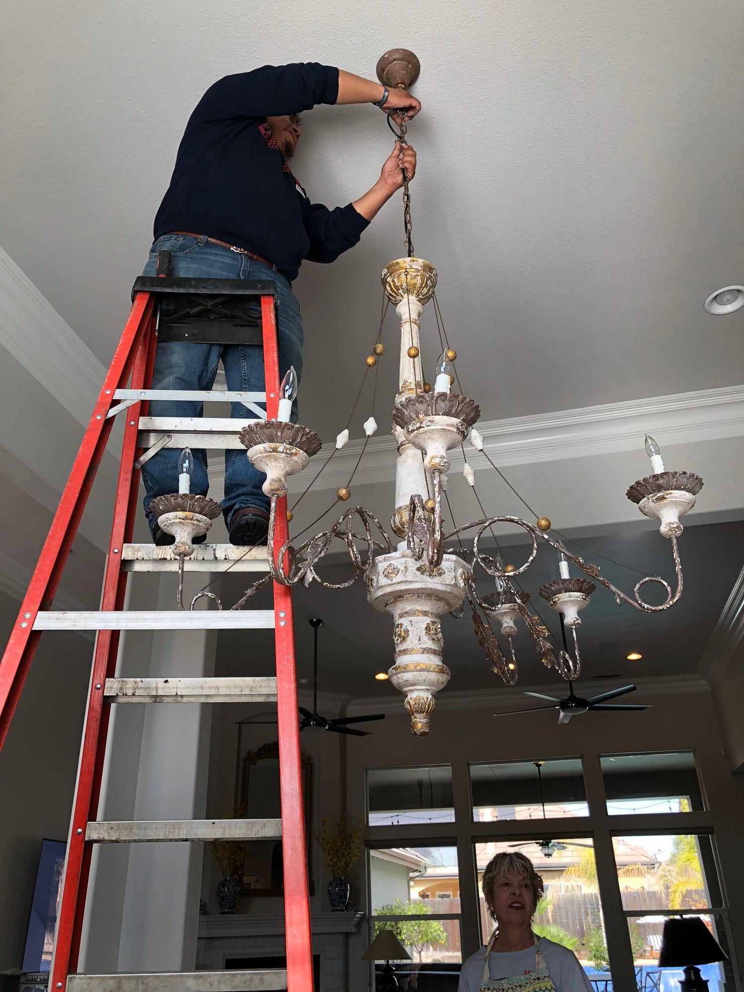 CMG Services team installing new chandelier