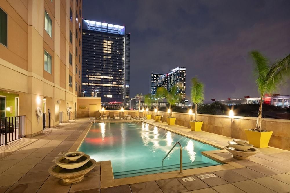 A large swimming pool in front of a building at night