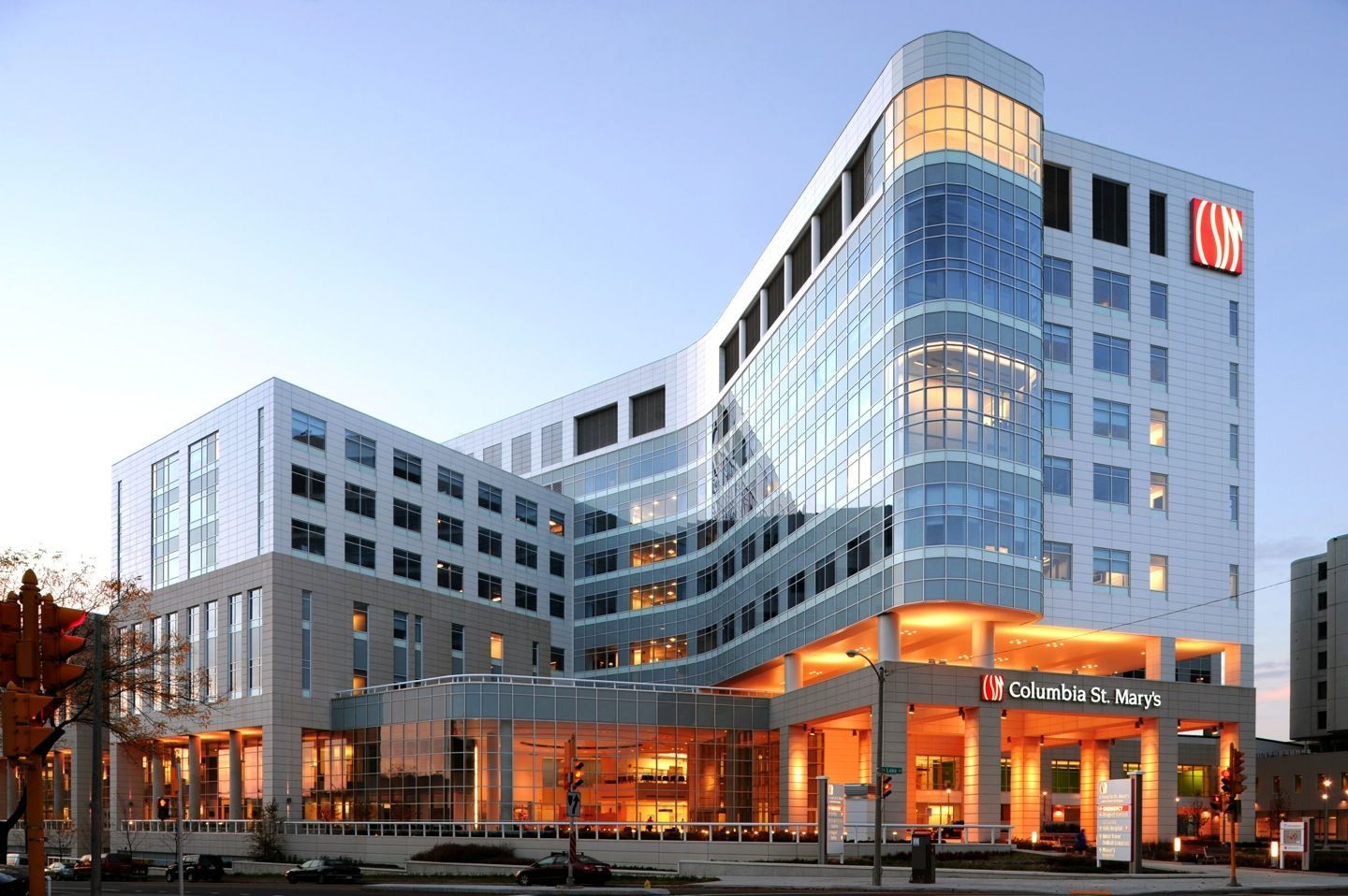 A large building with a lot of windows is lit up at night.