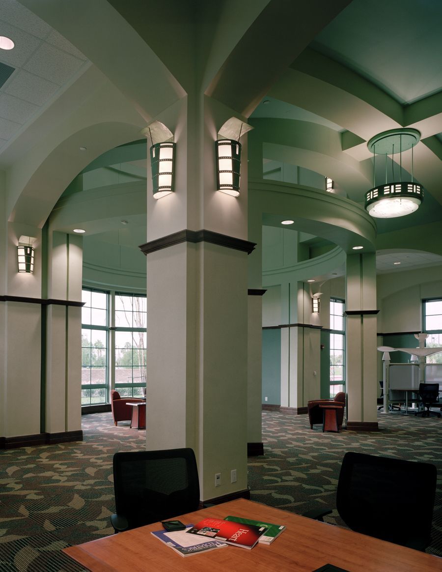 A room with columns and a table with a book on it